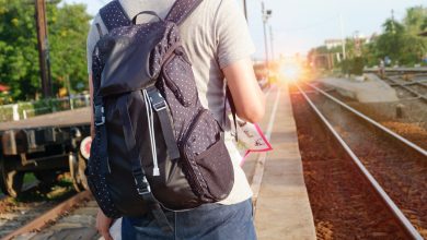 man on train station with backpack